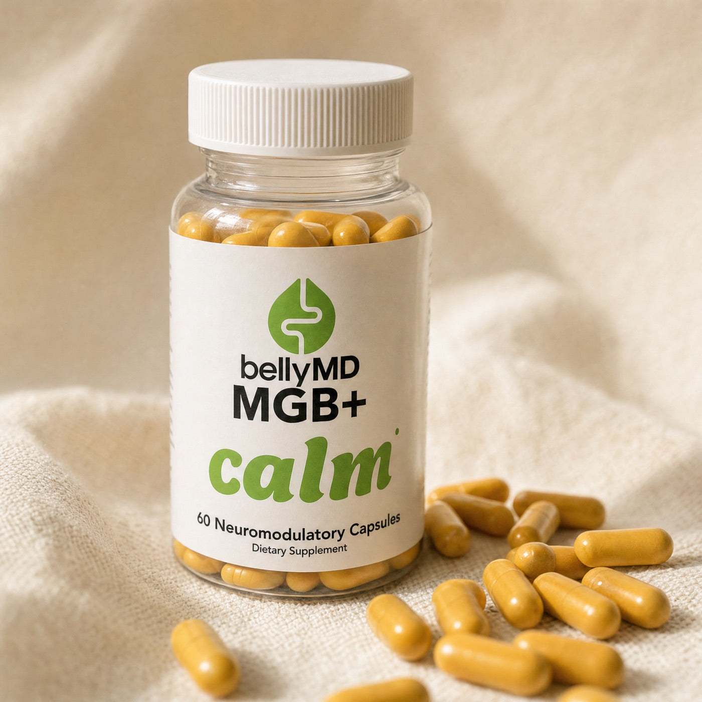 MGB+ Calm bottle with yellow capsules spilled beside it on linen