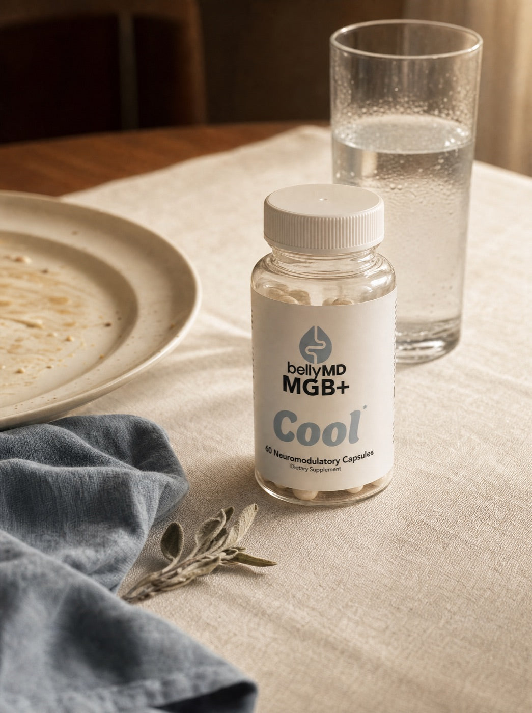 MGB+ Cool bottle on a dinner table beside a finished plate and a glass of water