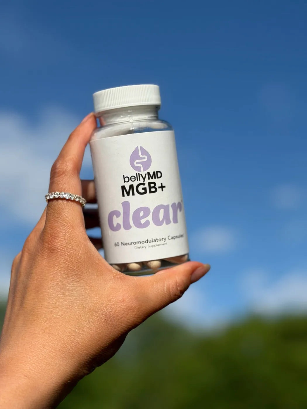 A customer holding a bottle of MGB+ Clear outdoors